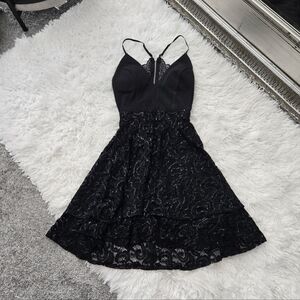 Royaal Share Love. Chic black dress with lace detailing. Perfect for special occ
